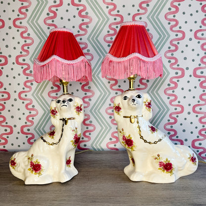 Pair of floral Staffordshire dog lamps with coral shades