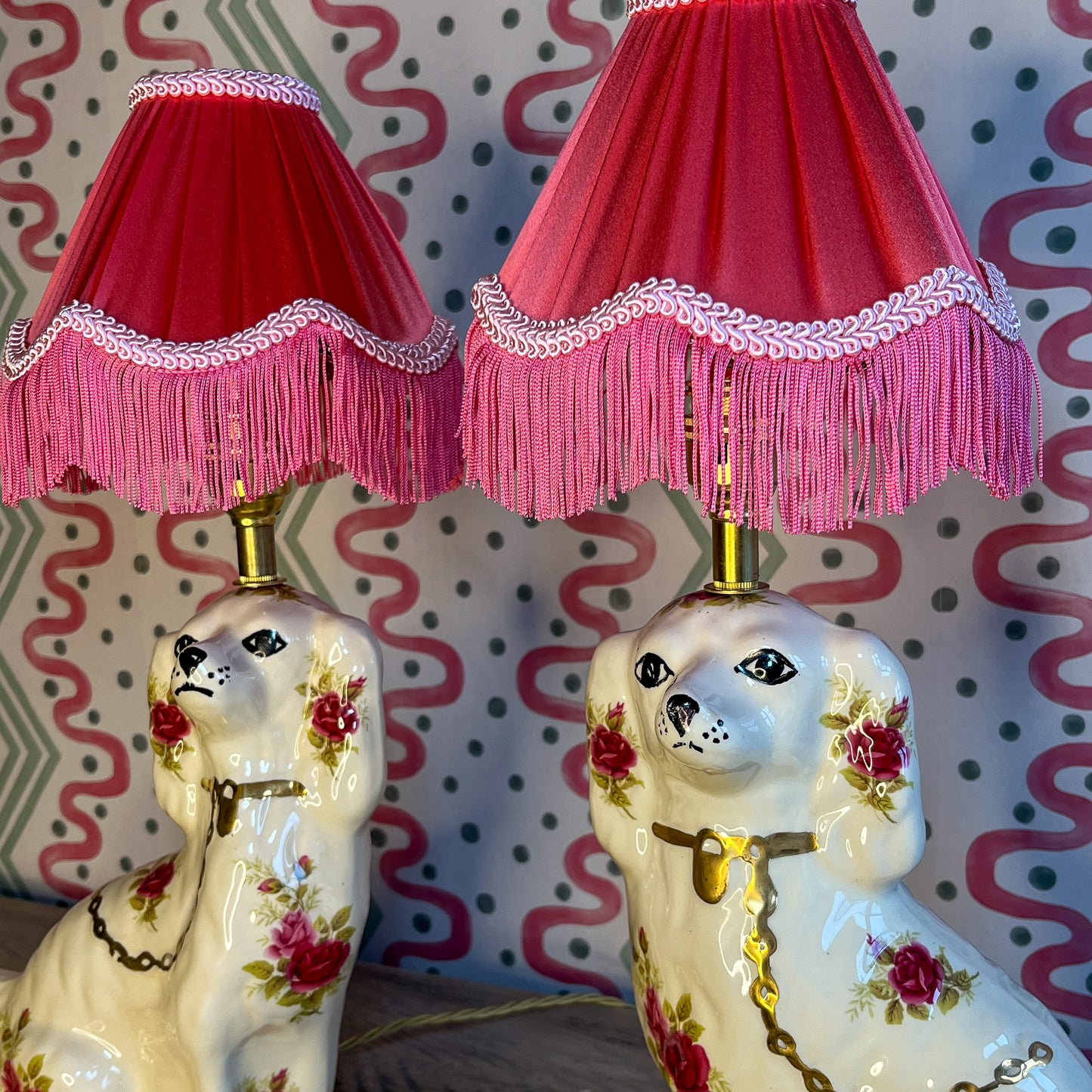 Pair of floral Staffordshire dog lamps with coral shades
