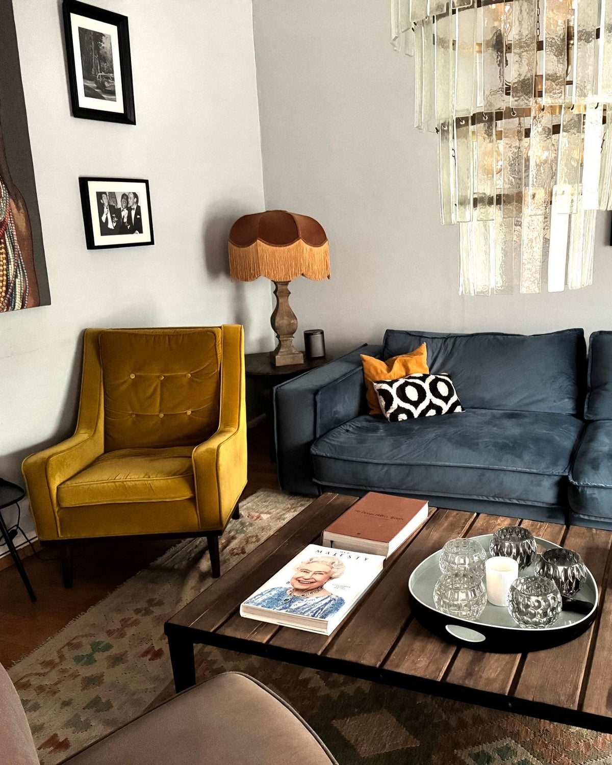 Brown velvet fringed table lamp beside a blue velvet sofa