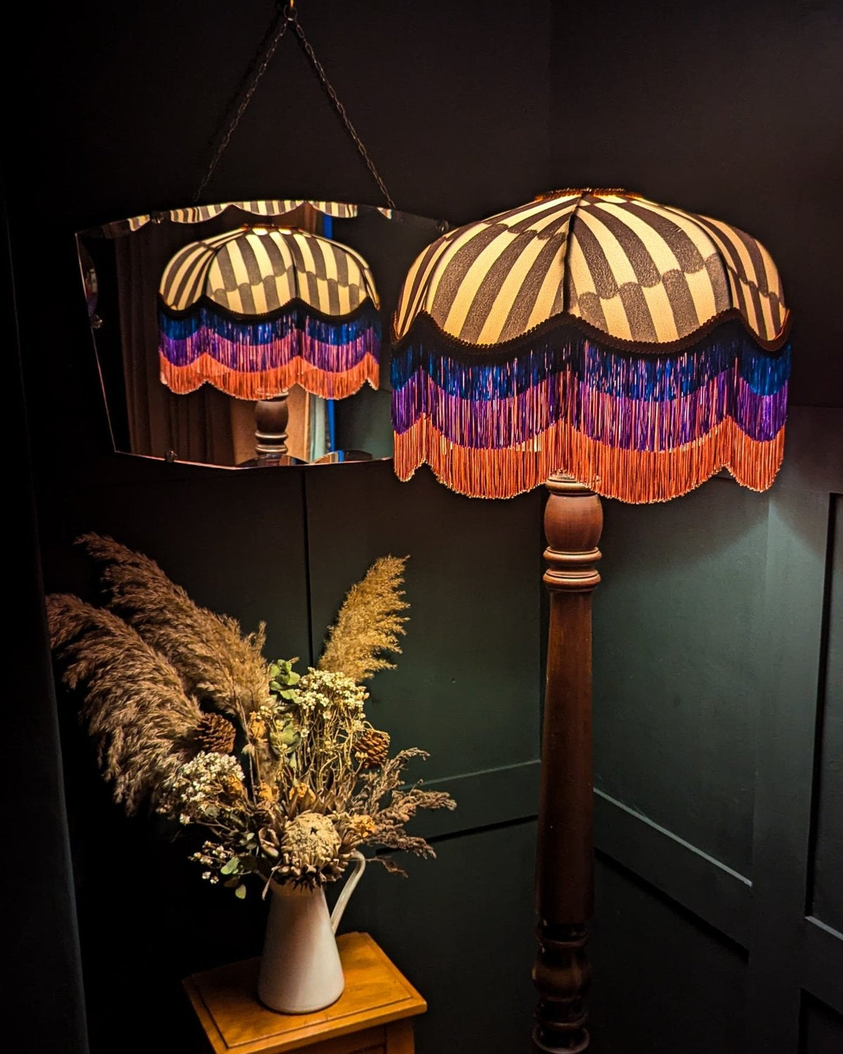 Striped lampshade with layered blue, purple and coral fringe